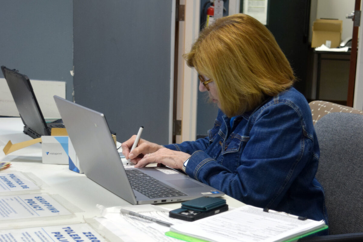 A volunteer at the check-in desk
