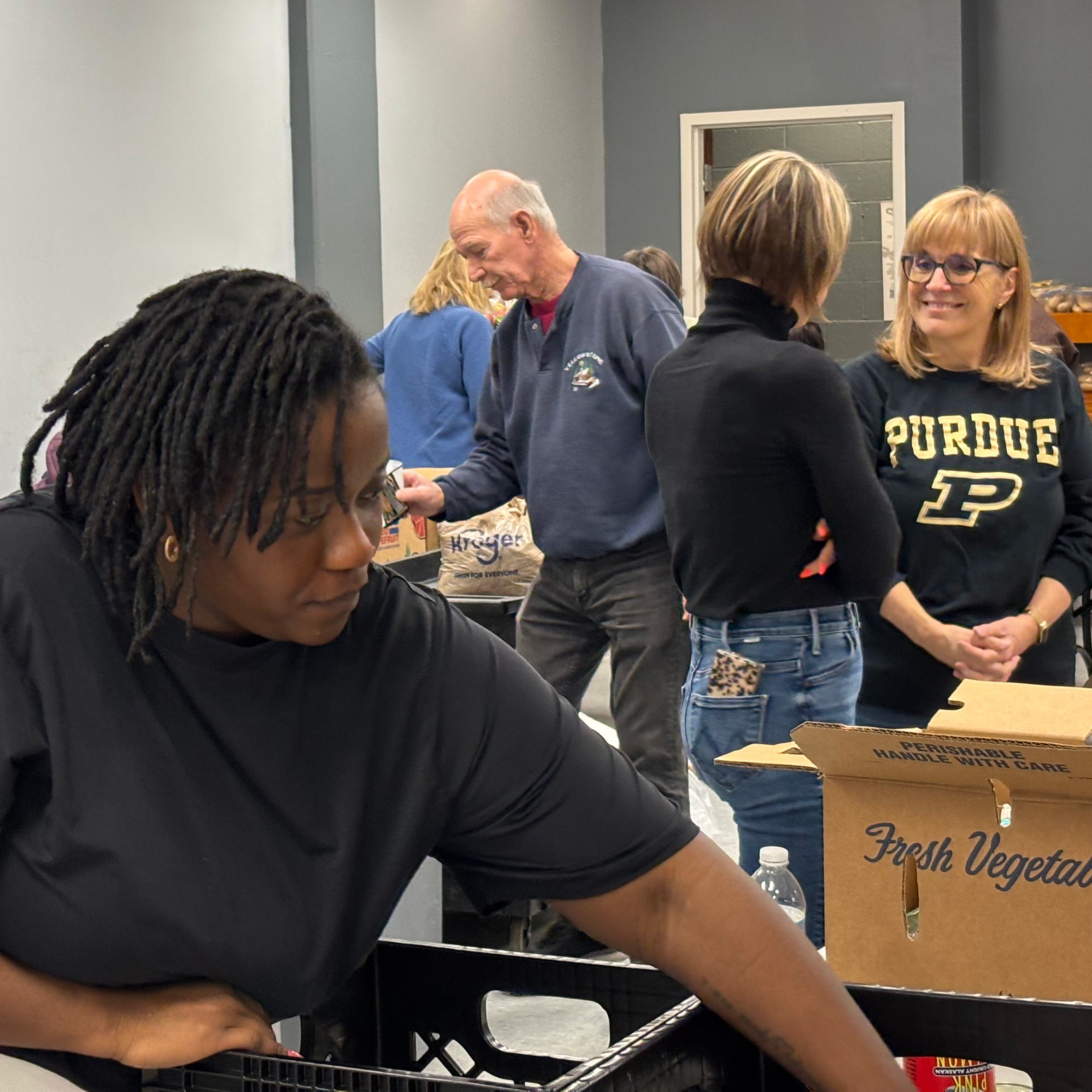 Volunteers at the food pantry, loading boxes and preparing food